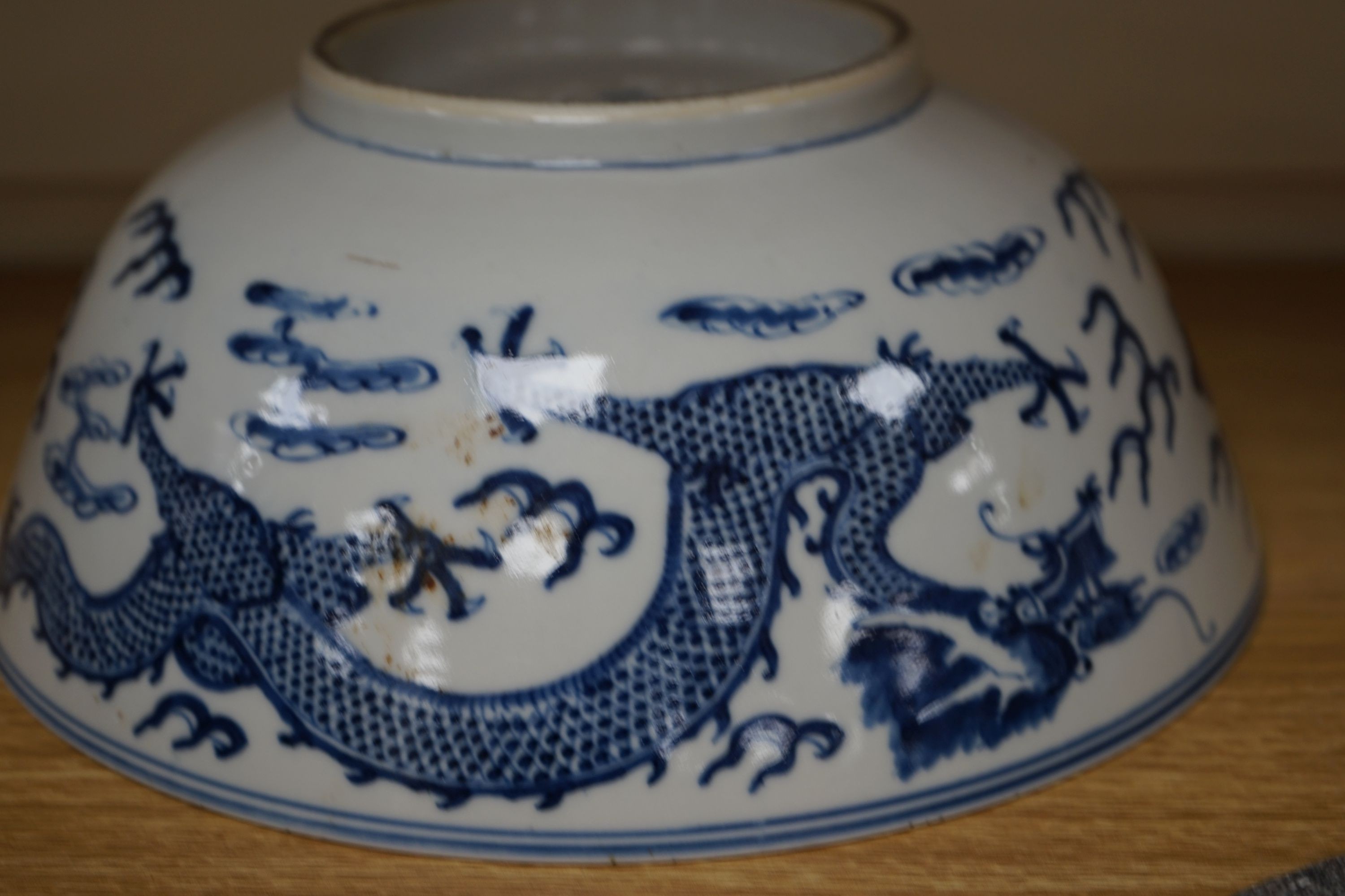 A Chinese blue and white ‘dragon’ bowl, Kangxi mark, late 19th century 25cm